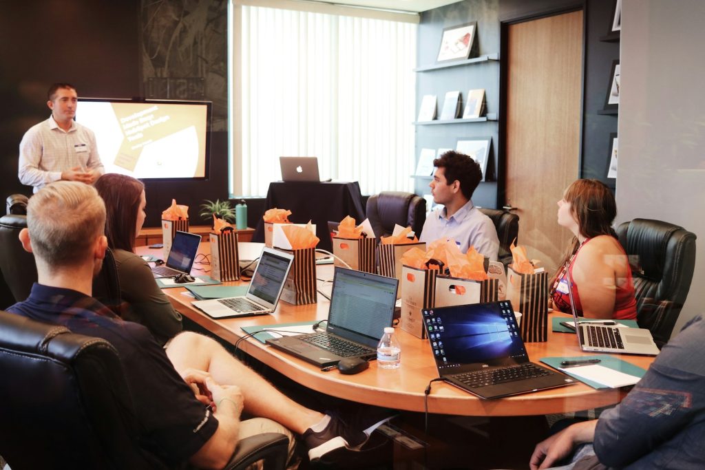 A colleague presenting to a team in a meeting room