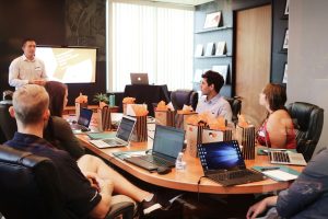 A colleague presenting to a team in a meeting room