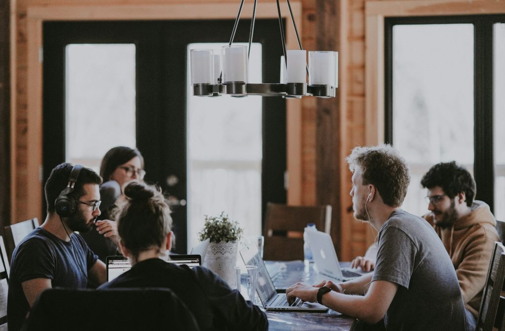 A team collaborating at a desk in a bright office