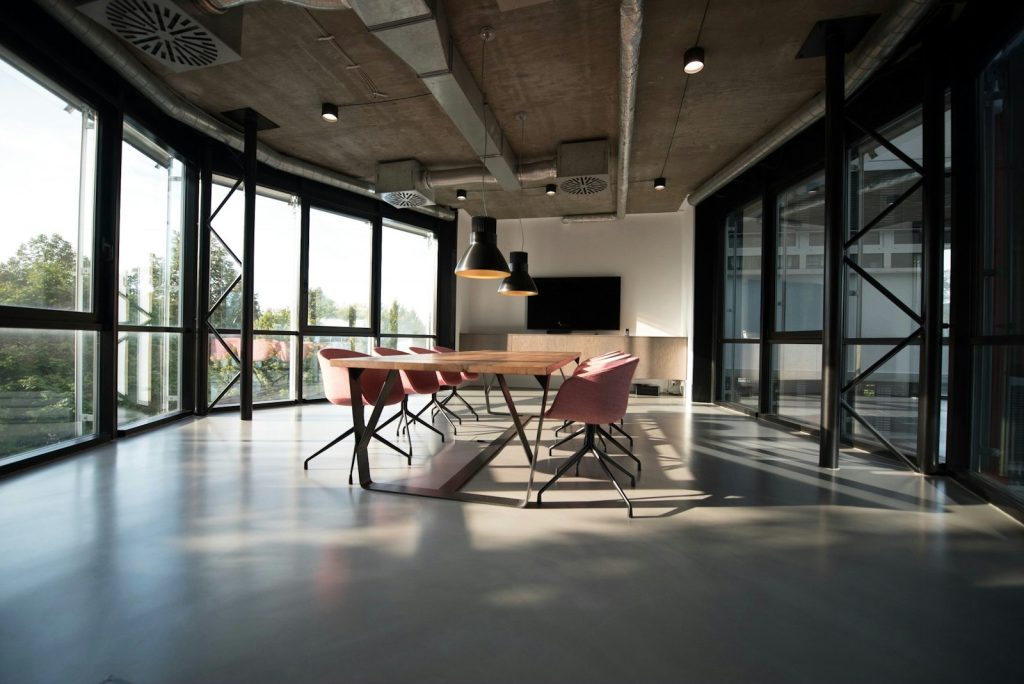 A modern office with desks and large windows