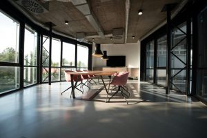 A modern office with desks and large windows