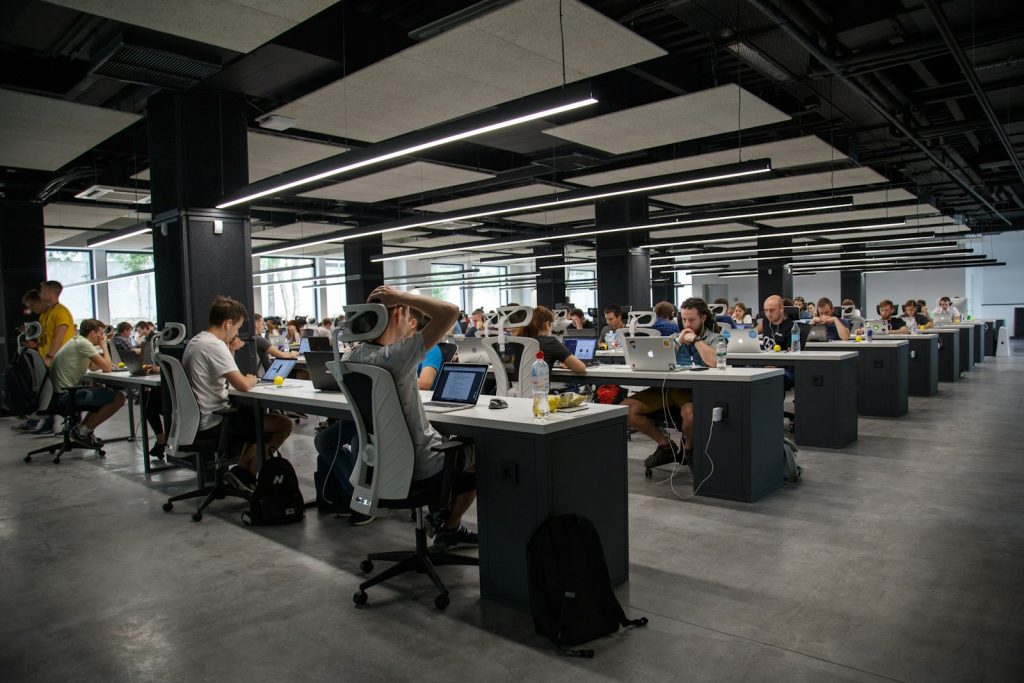 People working at laptops in a shared office space