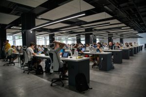 People working at laptops in a shared office space