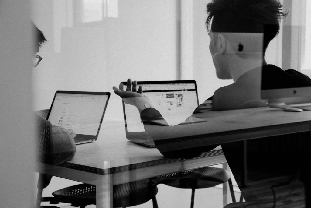Two colleagues reviewing work together at a desk